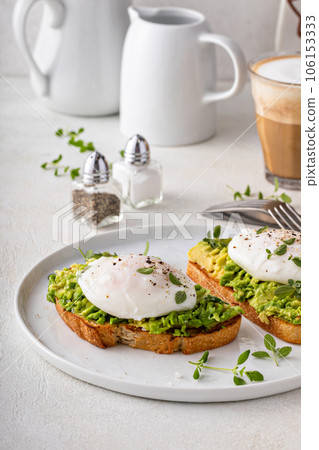 Avocado toast with a poached egg on top Avocado toast with a poached egg on top 106153333