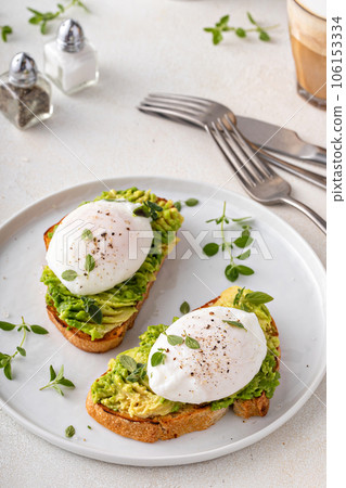 Avocado toast with a poached egg on top Avocado toast with a poached egg on top 106153334