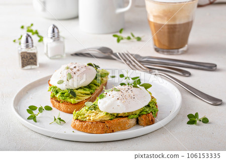 Avocado toast with a poached egg on top Avocado toast with a poached egg on top 106153335
