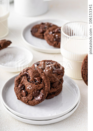 Double chocolate cookies with dark chocolate chips and salt flakes Double chocolate cookies with dark chocolate chips and salt flakes 106153341