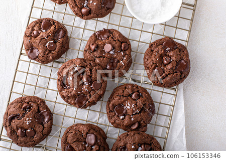 Double chocolate cookies with dark chocolate chips and salt flakes Double chocolate cookies with dark chocolate chips and salt flakes 106153346