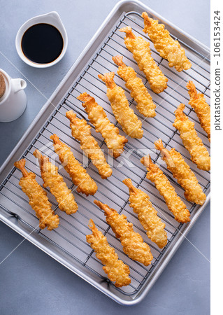 Tempura shrimp just cooked on a cooling rack 106153424