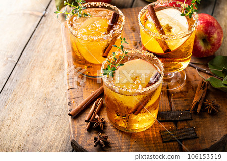 Apple cider margarita with brown sugar rim and cinnamon stick Apple cider margarita with brown sugar rim and cinnamon stick 106153519