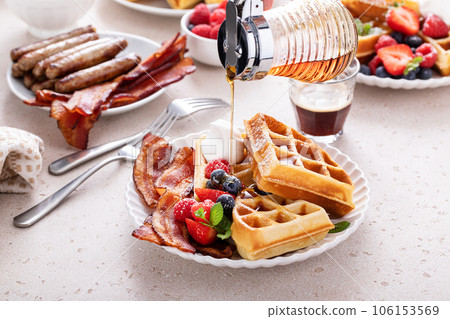 Breakfast table with waffles, croissants and bacon Breakfast table with waffles, croissants and bacon 106153569