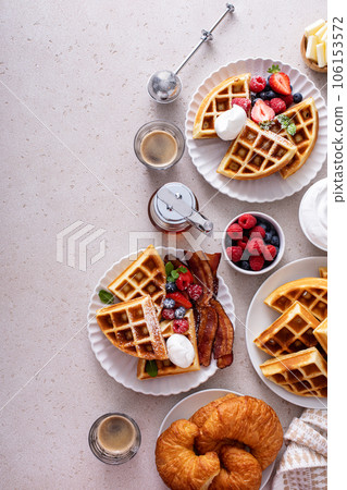Breakfast table with waffles, croissants and bacon Breakfast table with waffles, croissants and bacon 106153572