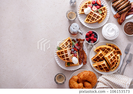 Breakfast table with waffles, croissants and bacon Breakfast table with waffles, croissants and bacon 106153573