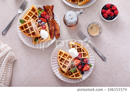 Breakfast table with waffles, berries and bacon Breakfast table with waffles, berries and bacon 106153574