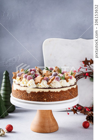 Christmas cake decorated with gingerbread cookies and sugared cranberry Christmas cake decorated with gingerbread cookies and sugared cranberry 106153632
