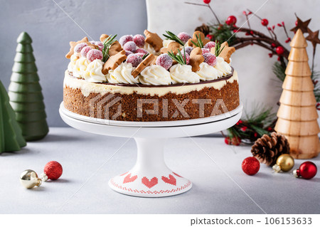 Christmas cake decorated with gingerbread cookies and sugared cranberry 106153633