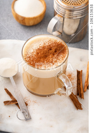 Coffee with collagen powder added topped with cinnamon 106153638