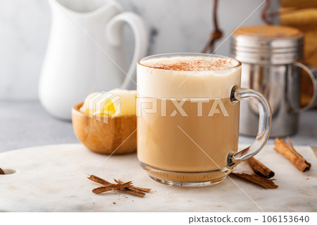 Bulletproof coffee in a glass mug with cinnamon 106153640