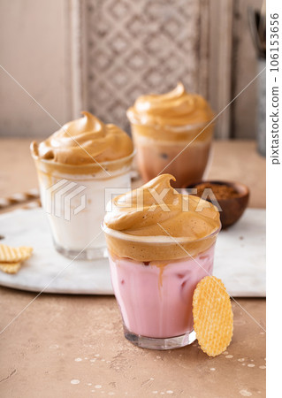 Strawberry, regular and chocolate dalgona whipped coffee in a glass with ice Strawberry, regular and chocolate dalgona whipped coffee in a glass with ice 106153656