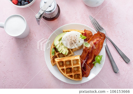Healthy waffle breakfast plate with avocado and poached egg Healthy waffle breakfast plate with avocado and poached egg 106153666