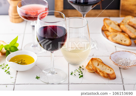 Variety of vine in different glasses with olive oil and baguette Variety of vine in different glasses with olive oil and baguette 106153690