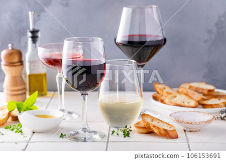 Variety of wine glasses with red, white and rose wine 106153691