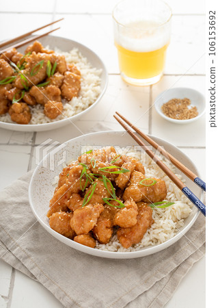Orange chicken in a bowl served with rice Orange chicken in a bowl served with rice 106153692