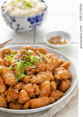 Orange chicken in a bowl served with rice Orange chicken in a bowl served with rice 106153694