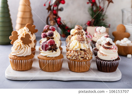 Variety of festive Christmas cupcakes on the table 106153707