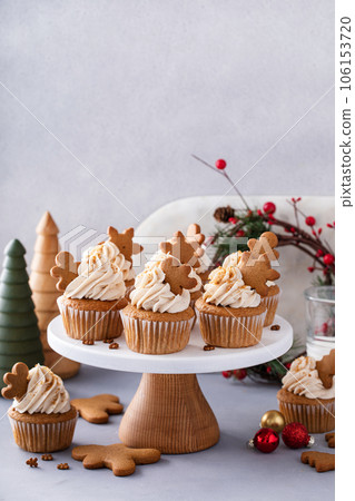 Gingerbread cupcakes with cream cheese frosting topped with gingerbread cookies Gingerbread cupcakes with cream cheese frosting topped with gingerbread cookies 106153720