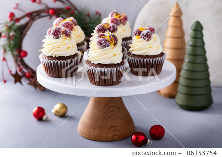Sugared cranberry and orange chocolate cupcakes with cream cheese frosting 106153754