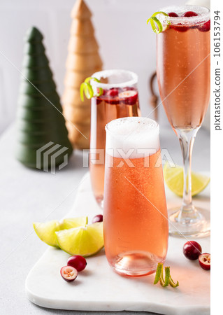 Christmas mimosa with cranberry juice and lime Christmas mimosa with cranberry juice and lime 106153794