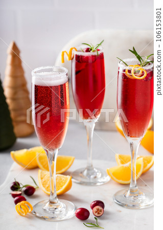 Christmas mimosa with cranberry juice and orange Christmas mimosa with cranberry juice and orange 106153801