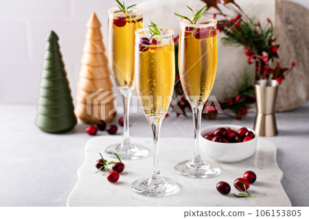 Festive Christmas mimosa with apple cider and cranberries Festive Christmas mimosa with apple cider and cranberries 106153805