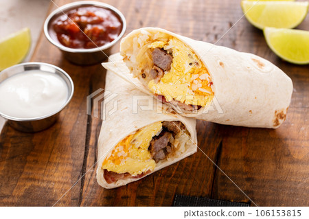 Breakfast burrito with sausage, eggs, hashbrown and cheese 106153815