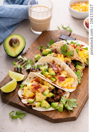 Breakfast tacos with sausage, eggs, bacon and avocado 106153827