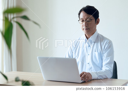 Middle man doing research on a laptop 106153916