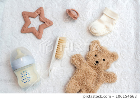 Newborn accessories displayed in flat lay, top view of essential infant items for care and comfort 106154668