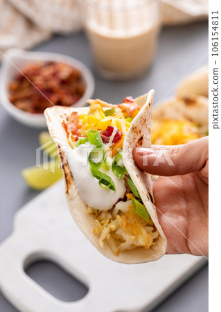 Breakfast tacos with hashbrowns, eggs and bacon 106154811