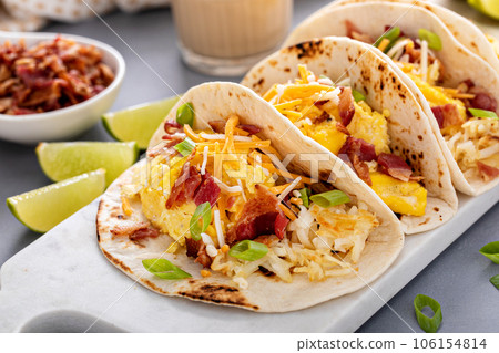 Breakfast tacos with hashbrowns, eggs and bacon 106154814