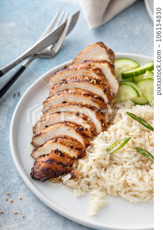 Grilled teriyaki chicken breast with rice and fresh cucumber Grilled teriyaki chicken breast with rice and fresh cucumber 106154830