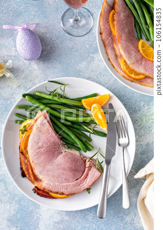 Easter ham served on a plate with green beans 106154835