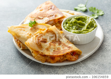 Shrimp and cheese quesadillas served with guacamole 106154859