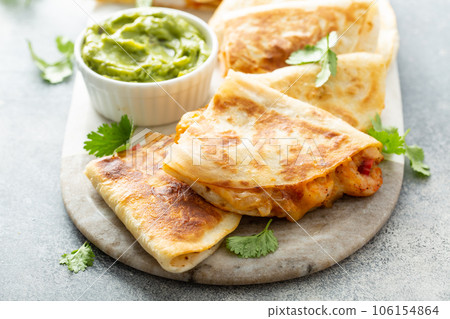 Shrimp and cheese quesadillas served with guacamole Shrimp and cheese quesadillas served with guacamole 106154864