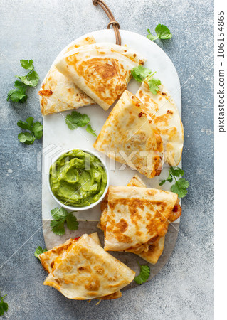 Shrimp and cheese quesadillas served with guacamole Shrimp and cheese quesadillas served with guacamole 106154865