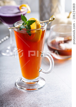 Hot fall cocktail, hot apple toddy with lemon in a glass Hot fall cocktail, hot apple toddy with lemon in a glass 106154869