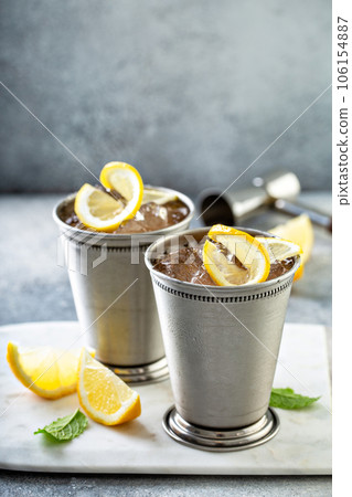 Lemon mint julep cocktail in traditional glasses 106154887