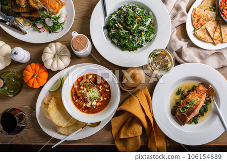 Fall dinner table overhead shot with salad and entrees Fall dinner table overhead shot with salad and entrees 106154889