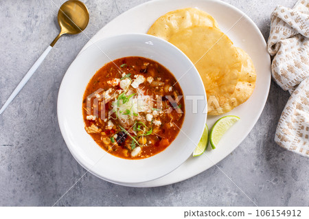 Mexican chicken soup topped with cotija cheese 106154912