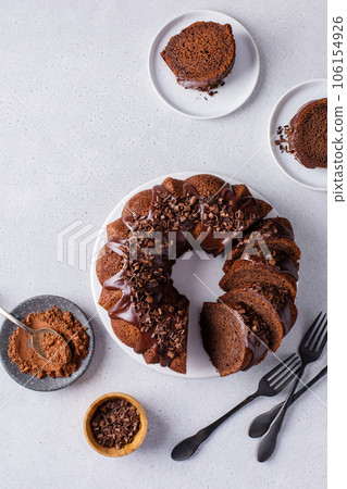 Chocolate cake baked in a bundt pan with chocolate ganache glaze Chocolate cake baked in a bundt pan with chocolate ganache glaze 106154926