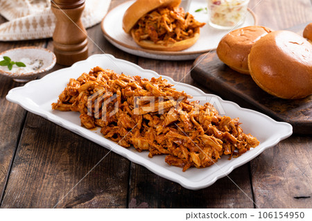 Pulled bbq chicken on a serving plate 106154950