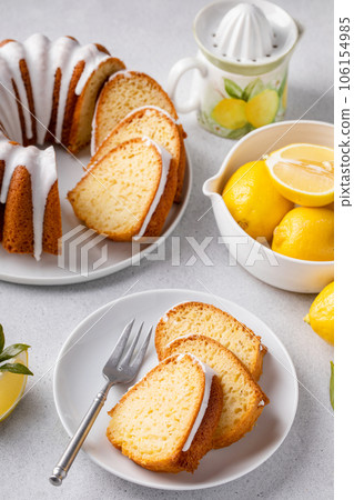 Lemon bundt cake drizzled with powdered sugar glaze 106154985