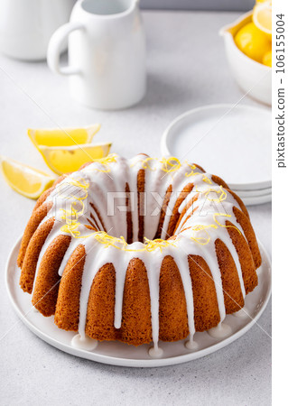 Lemon bundt cake drizzled with powdered sugar glaze 106155004