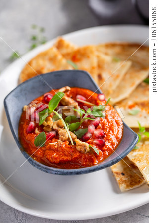 Muhammara, roasted bell pepper spread, served with roti Muhammara, roasted bell pepper spread, served with roti 106155068