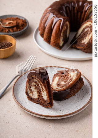 Chocolate marble bundt cake with chocolate glaze drizzled on top 106155550