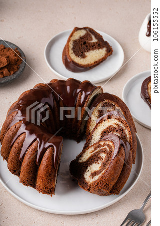 Chocolate marble bundt cake with chocolate glaze drizzled on top Chocolate marble bundt cake with chocolate glaze drizzled on top 106155552