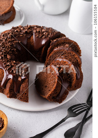 Chocolate cake baked in a bundt pan with chocolate ganache glaze Chocolate cake baked in a bundt pan with chocolate ganache glaze 106155584